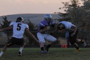 Bubba Ivers, the Moffat County High School quarterback, attempts to juke a Rifle High School defender. The Bulldogs lost 45-0 to Rifle at the Bulldog Proving Grounds Friday night.