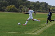 Moffat County High School senior Bryant Cox takes a shot during the team's game versus Rifle High School Tuesday at Loudy-Simpson Park. Cox would score the Bulldogs' first goal to tie the game at one.