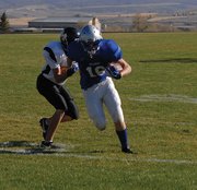 Brett Loyd, a freshman from Moffat County High School, shakes a tackler on his way into the end zone Monday during the MCHS C football game vs. Meeker at the Bulldog Proving Grounds.