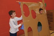 Sunset students hold a football toss game they created out of cardboard and recycled materials as part of the Cardboard Challenge on Friday morning. The challenge was to celebrate imagination day.