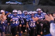 The Bulldogs run out through the fan tunnel before Friday night's game at the Bulldog Proving Grounds.