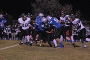 A host of Bulldogs, including Tyler Hildebrandt (No. 56) sack the Summit quarterback Friday night at the Bulldog Proving Grounds.