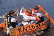 From left, Ashley Suits, Chelsie Smith and Jessie Suits compete Friday in the Great Cardboard Boat Regatta at Loudy-Simpson Park. Their ship, "Knight and Armour," stayed afloat for the entire course.