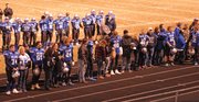 Seniors from the Moffat County football team stand with their parents and family members before Friday's game in Craig. Moffat County has 16 seniors on the roster this year, and they were honored along with the senior trainers and cheerleaders.