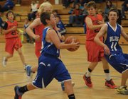 Eighth-grader Mike Bingham goes to the hoop on a fast break during the CMS vs. Hayden basketball game Saturday morning at CMS.