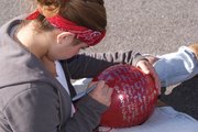 Alex Hamilton, an eighth grader at Craig Middle School, writes a drug free message on her red balloon Tuesday afternoon. It’s red ribbon week, and in an effort to encourage students to stay drug free the entire middle school released balloons with messages Tuesday afternoon along with hearing a presentation from Craig resident Matt Beckett about his own struggle with drugs and alcohol.