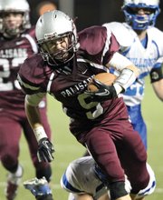 Palisade's Tass Crow slips through a tackle attempt to pick up yardage during the third quarter of Friday's game against Moffat County at Stocker Stadium.