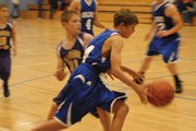 A Craig Middle School eighth-grader drives past his defender from Snake River during the eighth-grade game Thursday night at CMS. The Bulldogs pulled away early and won over a tough Rattlers team, 28-22.