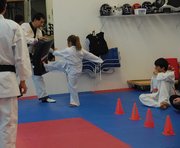 Children went through an obstacle course testing their agility and taekwondo techniques at Northwest Colorado Taekwondo class Monday afternoon at 420 Breeze St. Here, a white belt works her way through the kicking station of the course.