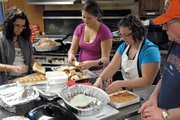 Volunteers make final preparations Thursday in anticipation of serving more than 150 residents who attended the third annual Thanksgiving dinner at The Community Soup Kitchen at St. Michael's Catholic Church.