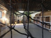 A view down one of the batting cage lanes, looking at the softball pitching machine as well as archery targets at InsideOut Sports, 561 Russel St.