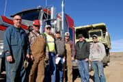 Lou Wyman, center, flanked from right by Guy Sanborn, Wayne Goodnow, Lonnie Parrish, Tony Peroulis, Jim Herschberg and Tyler Ripka, welcomes Tuesday the arrival of a Euclid 302LD Dump Truck at the Wyman Museum. The Euclid was donated by Trapper Mine.