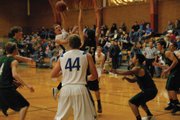 Joe Camilletti makes a pass through the defense for teammate Tyler Hildebrandt (44). Hildebrandt was fouled on the play, and the Bulldogs won 56-49 over Rangely Friday night.