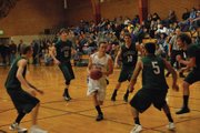 Junior Taft Cleverly drives through the Rangely defense during their game Friday night in Meeker. Moffat County won, 56-49.