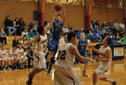 Miguel Cruz puts up a shot versus Meeker on Saturday at Meeker High School. Cruz put in a basket late in the close game to help the Bulldogs maintain their lead and pull out a win.