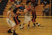 Lisa Camilletti (14) wheels between defenders to put up a shot during the girls basketball team's game against Grand Valley Thursday at Moffat County High School. Camilletti had 10 points and the Bulldogs won, 52-31
