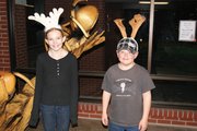 Nikki Currie, a fifth grader at Sandrock,left, and Garrett Anson, a second grader at East, play around as reindeer Thursday at the Moffat County Youth United Way and Key Club's Festival of Trees.