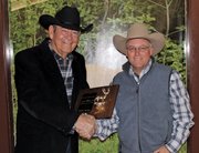 Tom Mikesell, right, Colorado Outfitter Association 2012 president, presents Craig resident Chris Jurney with the COA's 2012 Outfitter of the Year Award. Jurney was recognized for his contributions to the outfitting industry, wildlife and wildlife management, and his commitment to the ideals of the COA.