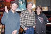 Greg Brewer, middle, Jayne McCormick, right, and Scott Dejardins pose for a photo last Saturday at The OP Bar and Grill after the 11th annual Poker Run hosted by the Northwest Colorado Snowmobile Club. Brewer, McCormick and Dejardins finished first, second and third, respectively.