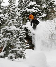 Nick Demarest watches Jordan Osterman drop off a rock in Fish Creek Canyon on Thursday. Demarest is a ski instructor, and Osterman is a ski patroller. Steamboat Ski Area has been busy during the past week rescuing skiers who venture into the backcountry and do not know where they are going.