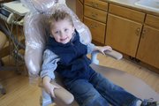 Mason Atkin, 3, sits in the chair at his father's dentist practice, Bears Ears Dental. Although Lee has built in access to dental care and education with his father, Dr. Lee Atkin DDS, many in Moffat County still lack in education about oral preventative measures.