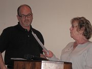 Joe Bird, left, accepts the Craig Chamber of Commerce's businessperson of the year award from Chamber Board member Gail Severson. Bird accepted the award on behalf of Scott Cook.