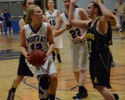 Sassy Murray looks for a teammate to pass to as two Jefferson defenders collapse on her. Murray scored seven points, all in the second half, as Moffat County won and moved on to the regional final Saturday.