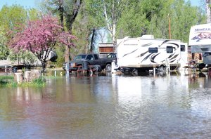 Several inches of water surround campers in the longterm section at the Steamboat Campground in west Steamboat Springs Tuesday morning. The water from the Yampa River has come into the park the past few nights but hasn't really been an issue. The management has offered to allow these campers to move to drier areas, but the owners of the campers elected to stay where they were feeling like the water is on its way back down.